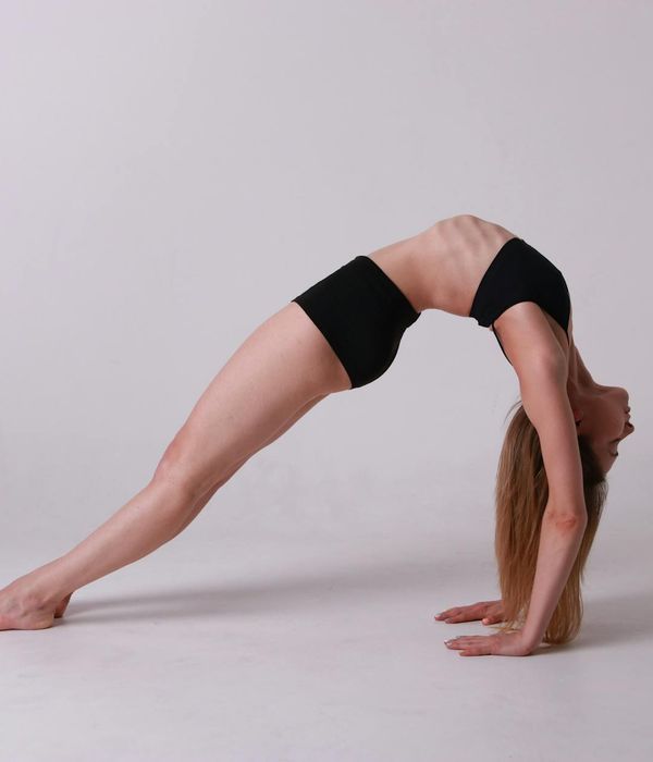 Woman in a calm yoga pose, embodying balance and flexibility.